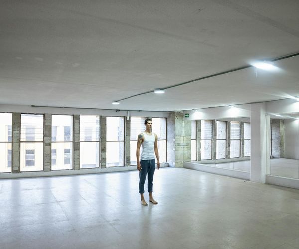 Bright and clean modern fitness studio with large windows and minimalist design.